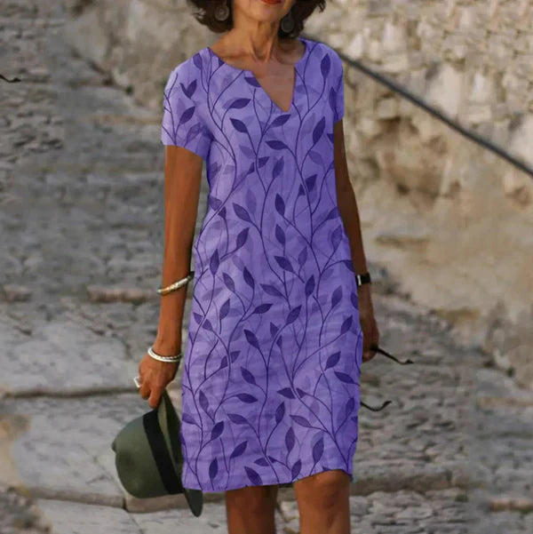 Abito corto fluido da donna con stampa foglie e scollo a V elegante